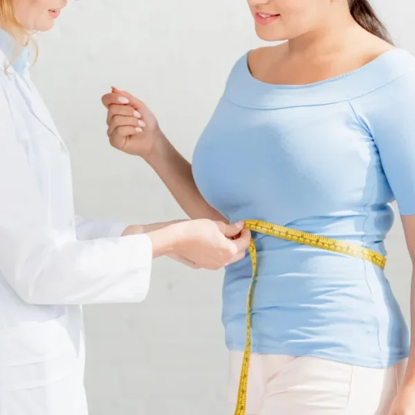 cropped-view-of-nutritionist-measuring-body-of-pat-2024-11-17-17-18-51-utc-scaled